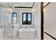 Elegant bathroom with a freestanding tub and glass shower at 517 Treviso Dr, Apollo Beach, FL 33572