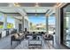 Covered patio with sectional sofa and fire pit, offering pool views at 519 Treviso Dr, Apollo Beach, FL 33572