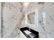 Elegant bathroom with marble tile and a sleek, illuminated mirror at 519 Treviso Dr, Apollo Beach, FL 33572