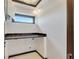 Modern laundry room with built-in countertop and window at 519 Treviso Dr, Apollo Beach, FL 33572