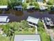 Aerial view showcasing a canal, boats, docks, and a private boat house at 519 Treviso Dr, Apollo Beach, FL 33572
