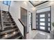 Elegant entryway with modern staircase and chandelier at 519 Treviso Dr, Apollo Beach, FL 33572
