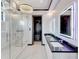 Luxurious bathroom with marble shower, double vanity, and modern fixtures at 519 Treviso Dr, Apollo Beach, FL 33572