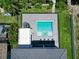 An overhead view of a modern, square-shaped pool with a hot tub and surrounding patio at 519 Treviso Dr, Apollo Beach, FL 33572