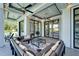 Spacious outdoor lounge with sectional sofa and glass doors at 519 Treviso Dr, Apollo Beach, FL 33572