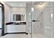 Elegant bathroom, featuring a frameless glass shower and double vanity at 519 Treviso Dr, Apollo Beach, FL 33572