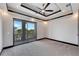 Spacious bedroom with balcony access and carpeted floors at 519 Treviso Dr, Apollo Beach, FL 33572