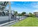 Modern home with a fenced-in pool, patio furniture and lush green lawn at 519 Treviso Dr, Apollo Beach, FL 33572