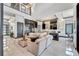 Open concept living area with a large sectional sofa and modern kitchen at 519 Treviso Dr, Apollo Beach, FL 33572