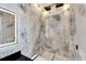 Luxury bathroom with marble walls, a glass shower, and modern fixtures at 519 Treviso Dr, Apollo Beach, FL 33572