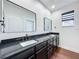 Double vanity bathroom with dark cabinetry and quartz countertops at 3511 Loggerhead Way, Wesley Chapel, FL 33544