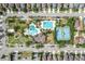 Aerial view of a community pool, tennis courts, playground and parking at 33346 Kateland Dr, Wesley Chapel, FL 33545