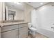Well-lit bathroom with granite countertop vanity and shower-tub combination at 33346 Kateland Dr, Wesley Chapel, FL 33545