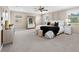 Large primary bedroom featuring neutral paint, ensuite bath, and large windows at 33346 Kateland Dr, Wesley Chapel, FL 33545