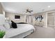 Spacious bedroom with neutral paint, ceiling fan, ensuite bath, and large windows at 33346 Kateland Dr, Wesley Chapel, FL 33545