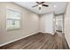 Bedroom featuring wood floors and natural light with a view into an en suite bathroom at 33346 Kateland Dr, Wesley Chapel, FL 33545