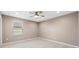 Neutral bedroom features carpet and a ceiling fan, offering a serene and comfortable space at 33346 Kateland Dr, Wesley Chapel, FL 33545