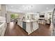 Open concept kitchen featuring a large center island with quartz countertop and stainless steel appliances at 33346 Kateland Dr, Wesley Chapel, FL 33545