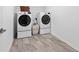 Well-lit laundry room featuring modern washer and dryer units and tiled flooring at 33346 Kateland Dr, Wesley Chapel, FL 33545