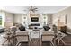 Bright and airy living room with stylish furnishings, fireplace, ceiling fan, and tile flooring at 33346 Kateland Dr, Wesley Chapel, FL 33545