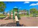 playground with slides and swings on a bright, sunny day at 33346 Kateland Dr, Wesley Chapel, FL 33545