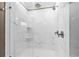 Modern shower with marble-style tile, glass enclosure, and multiple shower heads for a luxurious experience at 33346 Kateland Dr, Wesley Chapel, FL 33545