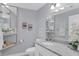 Modern bathroom with gray walls, white cabinets, and a granite countertop at 4302 Deepwater Ln, Tampa, FL 33615