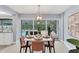 Bright dining area with seating for four, sliding glass doors to the pool at 4302 Deepwater Ln, Tampa, FL 33615