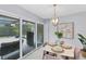 Bright dining area with seating for four and sliding glass doors to the patio at 4302 Deepwater Ln, Tampa, FL 33615