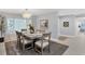 Spacious dining area with modern light fixture, seating for six at 4302 Deepwater Ln, Tampa, FL 33615