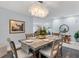 Elegant dining room featuring a rustic table and chandelier at 4302 Deepwater Ln, Tampa, FL 33615