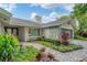 House exterior with a stone facade and a walkway leading to the entrance at 4302 Deepwater Ln, Tampa, FL 33615