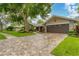 Home's exterior showcasing a paved driveway and lush landscaping at 4302 Deepwater Ln, Tampa, FL 33615