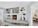 Stone fireplace with built-in shelving and a modern design at 4302 Deepwater Ln, Tampa, FL 33615