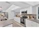 Modern kitchen with white cabinets, granite countertops, and stainless steel appliances at 4302 Deepwater Ln, Tampa, FL 33615
