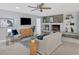 Cozy living room with fireplace, built-in shelving, and hardwood floors at 4302 Deepwater Ln, Tampa, FL 33615