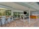 Outdoor patio with pool view, bar stools, dining table, and hot tub at 4302 Deepwater Ln, Tampa, FL 33615