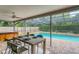 Relaxing pool and spa area with covered patio and outdoor dining at 4302 Deepwater Ln, Tampa, FL 33615