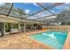 Large, refreshing pool with a screened enclosure and spacious patio at 4302 Deepwater Ln, Tampa, FL 33615