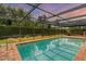 Relaxing screened-in pool with brick pavers surrounding it at 4302 Deepwater Ln, Tampa, FL 33615
