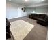 Spacious bonus room with large sectional sofa and area rug at 6013 Caldera Ridge Dr, Lithia, FL 33547