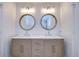Elegant bathroom with double vanity, quartz countertop and oval mirrors at 20131 Nob Oak Ave, Tampa, FL 33647