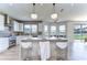 Modern kitchen with white cabinets, marble countertops, and stainless steel appliances at 20131 Nob Oak Ave, Tampa, FL 33647