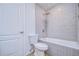 Clean bathroom with gray tile, a tub, and a toilet at 20131 Nob Oak Ave, Tampa, FL 33647