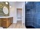 Spa-like bathroom with blue tile shower and marble vanity at 20131 Nob Oak Ave, Tampa, FL 33647