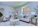 Living room featuring a light beige sofa and a large window at 20131 Nob Oak Ave, Tampa, FL 33647