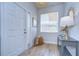 Bright and airy entryway with light gray console table and white door at 20131 Nob Oak Ave, Tampa, FL 33647