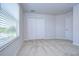 Spacious bedroom with neutral walls, carpet flooring, and a large window with blinds at 20131 Nob Oak Ave, Tampa, FL 33647