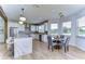 Open concept kitchen and dining area with white cabinets and light wood floors at 20131 Nob Oak Ave, Tampa, FL 33647