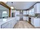 Modern kitchen featuring white cabinets, stainless steel appliances, and a large island at 20131 Nob Oak Ave, Tampa, FL 33647
